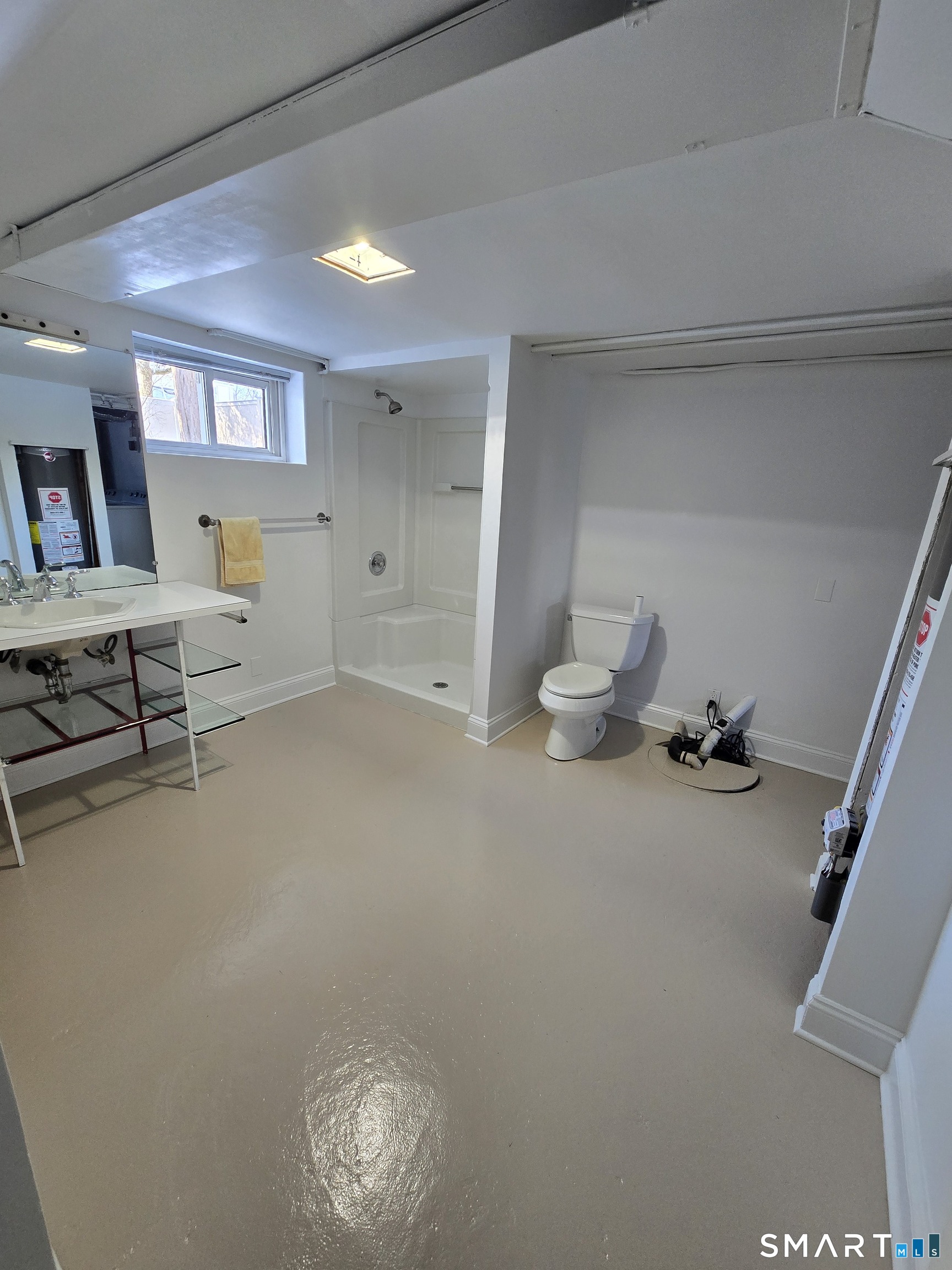 148 Catherine Street Fairfield, CT 06824 - Photo 16 of 25 a room with gym equipment and a view of living room