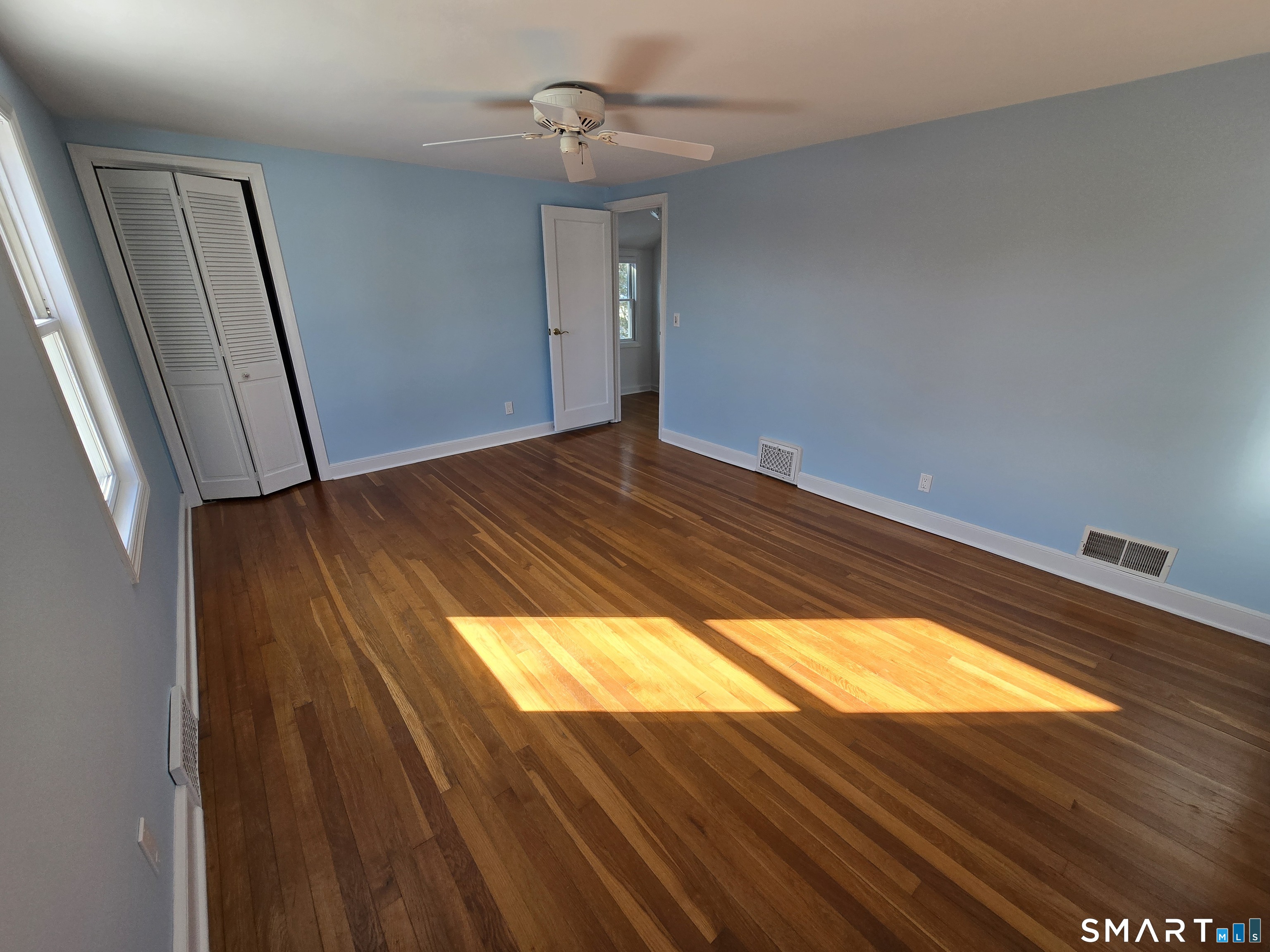 148 Catherine Street Fairfield, CT 06824 - Photo 22 of 25 a view of an empty room and wooden floor
