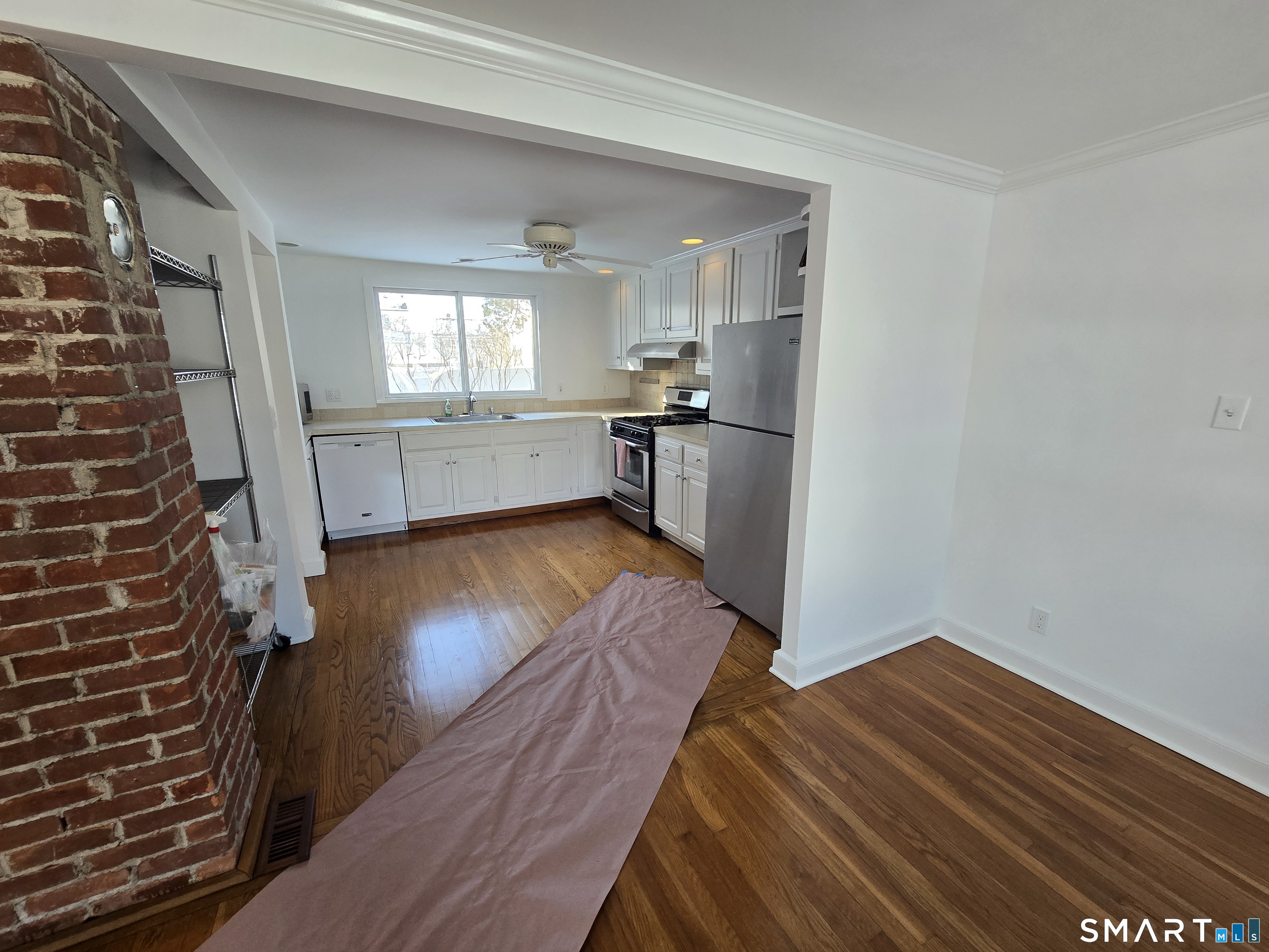 148 Catherine Street Fairfield, CT 06824 - Photo 6 of 25 a view of kitchen and hall with wooden floor