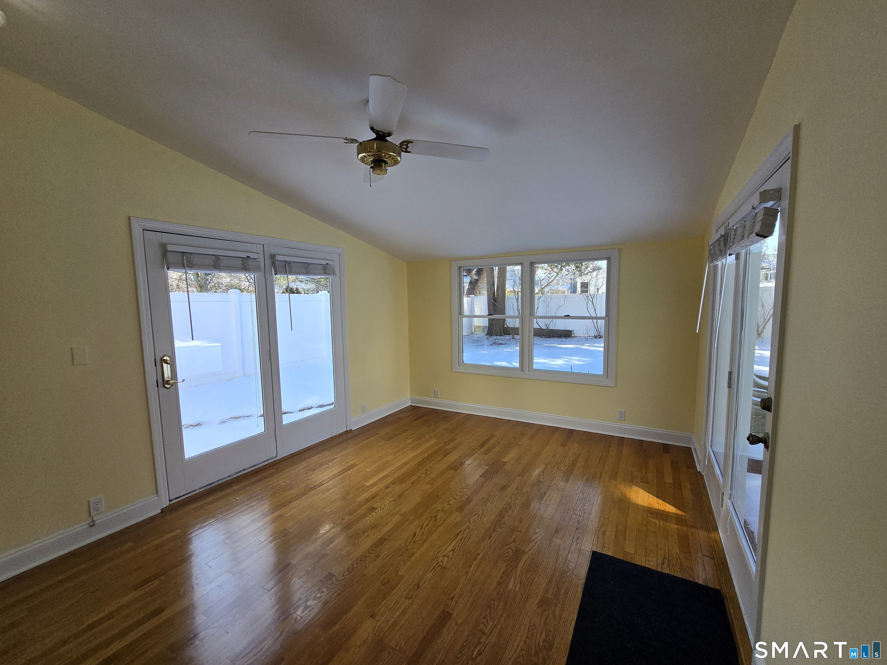 148 Catherine Street Fairfield, CT 06824 - Photo 8 of 25 a view of an empty room with a window and wooden floor