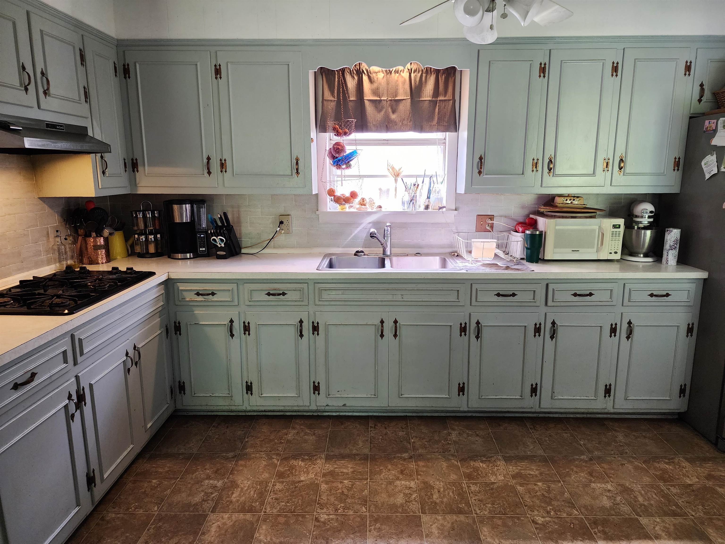 1607 Curve Nankipoo Road Ripley, TN 38063 - Photo 4 of 8 a kitchen with stainless steel appliances a sink stove and cabinets