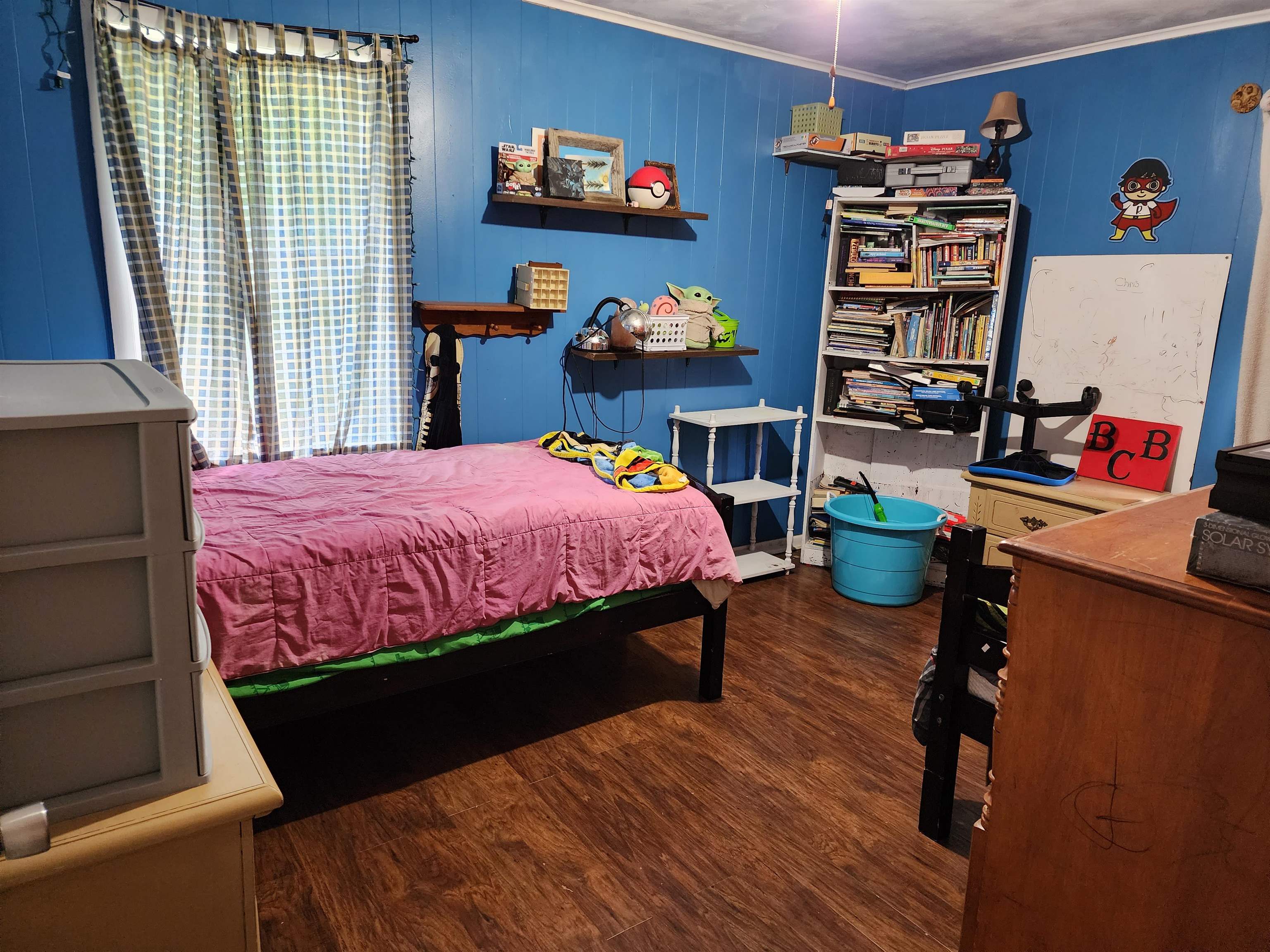 1607 Curve Nankipoo Road Ripley, TN 38063 - Photo 7 of 8 a bedroom with a bed and a wooden floor