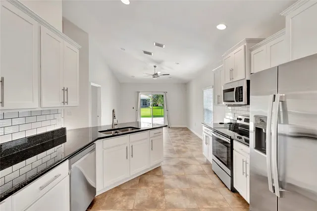 a kitchen with stainless steel appliances a sink stove and refrigerator