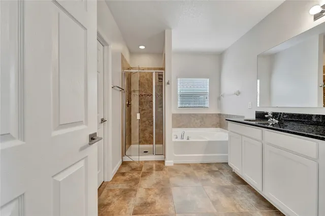 a bathroom with a tub sink and mirror