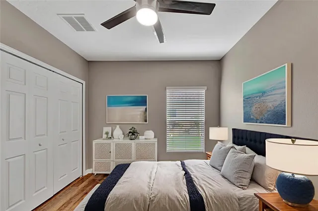 a bedroom with a bed and a view of kitchen