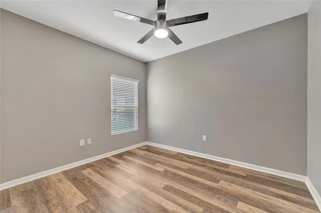 a view of a room with a ceiling fan and a window