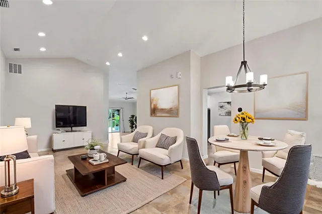 a living room with furniture a flat screen tv and a window