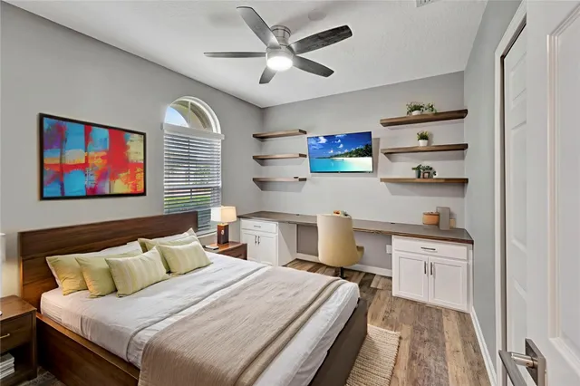 a bedroom with a bed and a chandelier