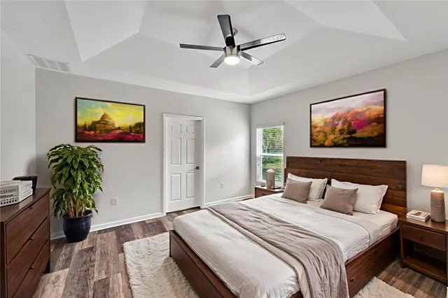 a bedroom with bed and a chandelier
