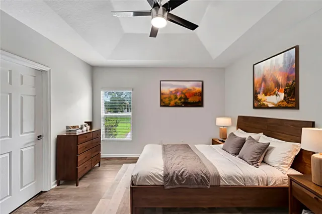 a bedroom with a bed and a chandelier