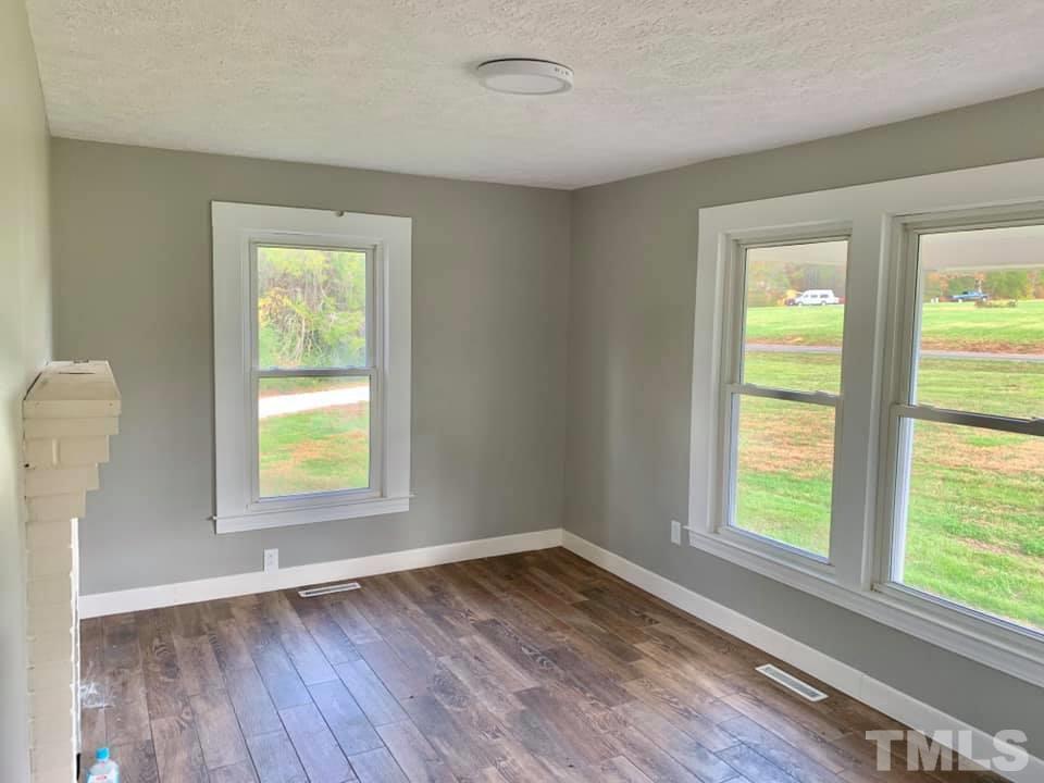71 Gentry Dunkley Road Roxboro, NC 27574 - Photo 2 of 14 an empty room with a window and wooden floor