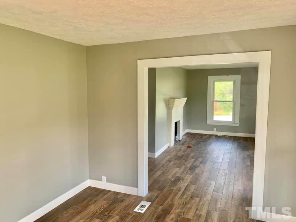 71 Gentry Dunkley Road Roxboro, NC 27574 - Photo 3 of 14 a view of a room with wooden floor and a window