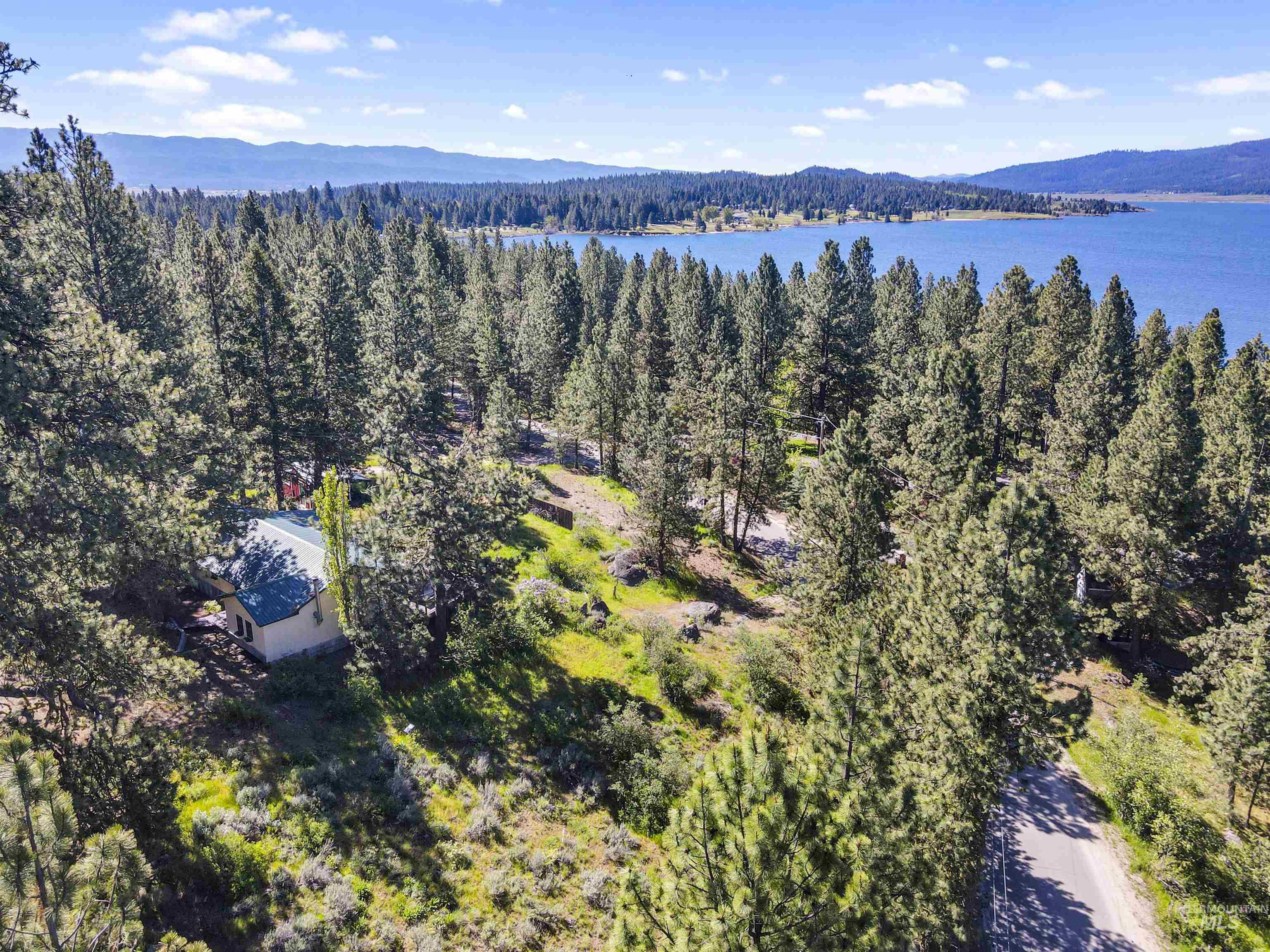 3 Laguna Place Cascade, ID 83611 - Photo 34 of 43 Expansive forested property featuring numerous mature evergreen trees, multiple structures, unpaved paths, and direct proximity to a large body of water