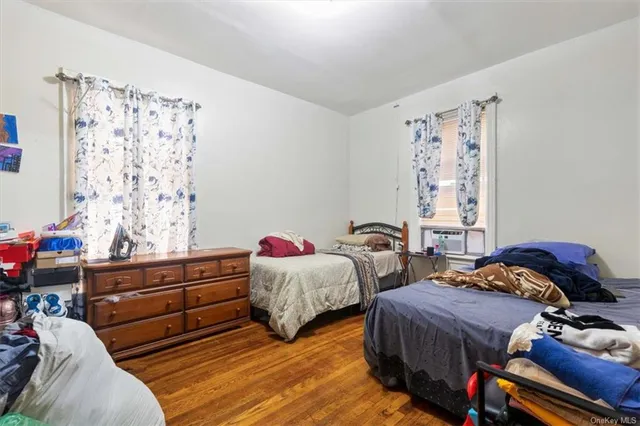 a bedroom with bed and wooden floor