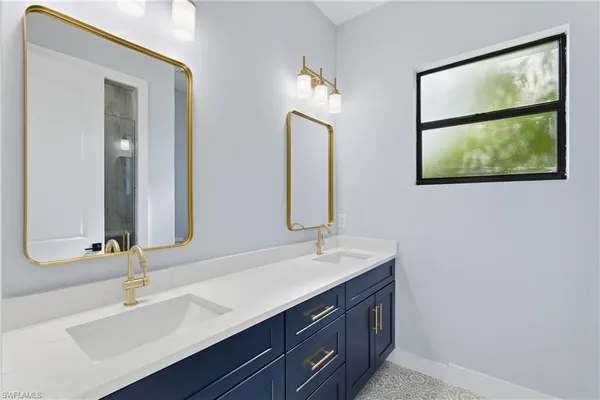 a bathroom with a double vanity sink and a mirror
