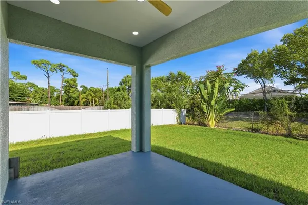 a front view of a house with yard and green space