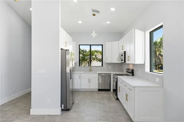 a kitchen with sink cabinets and window