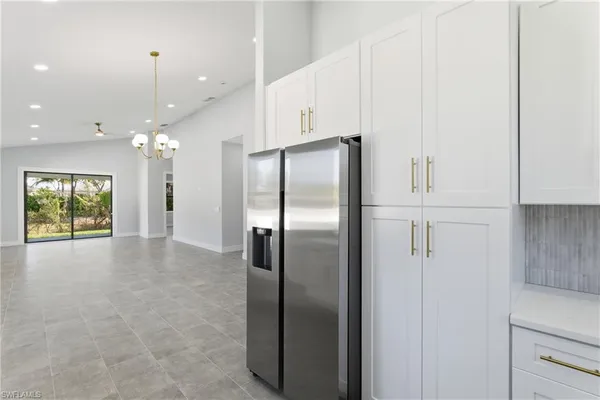 a kitchen with windows and refrigerator