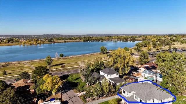 an aerial view of a houses with a lake view