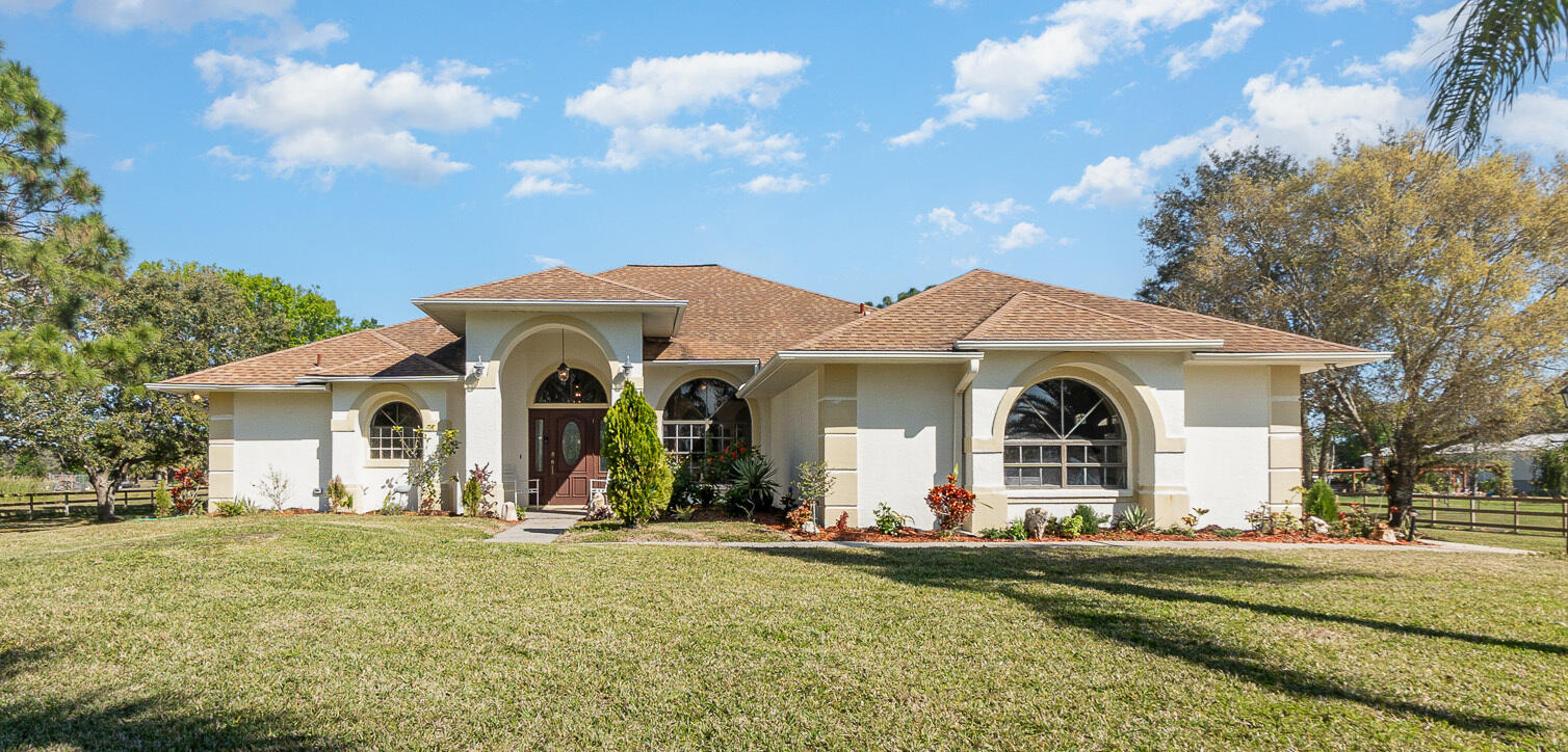 234 Deer Run Road Palm Bay, FL 32909 - Photo 1 of 50 a front view of a house with garden