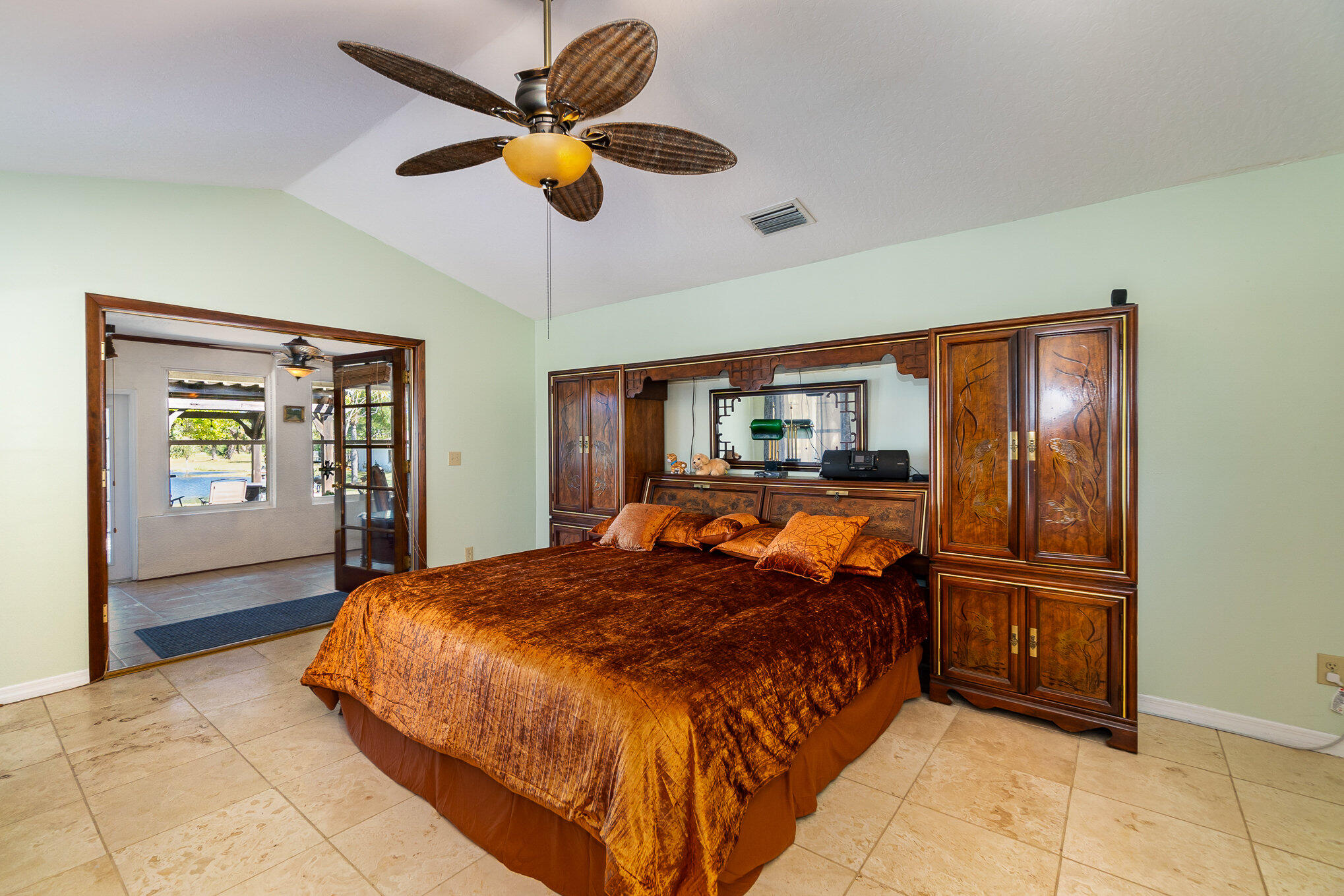 234 Deer Run Road Palm Bay, FL 32909 - Photo 16 of 50 a bedroom with a bed and a chandelier