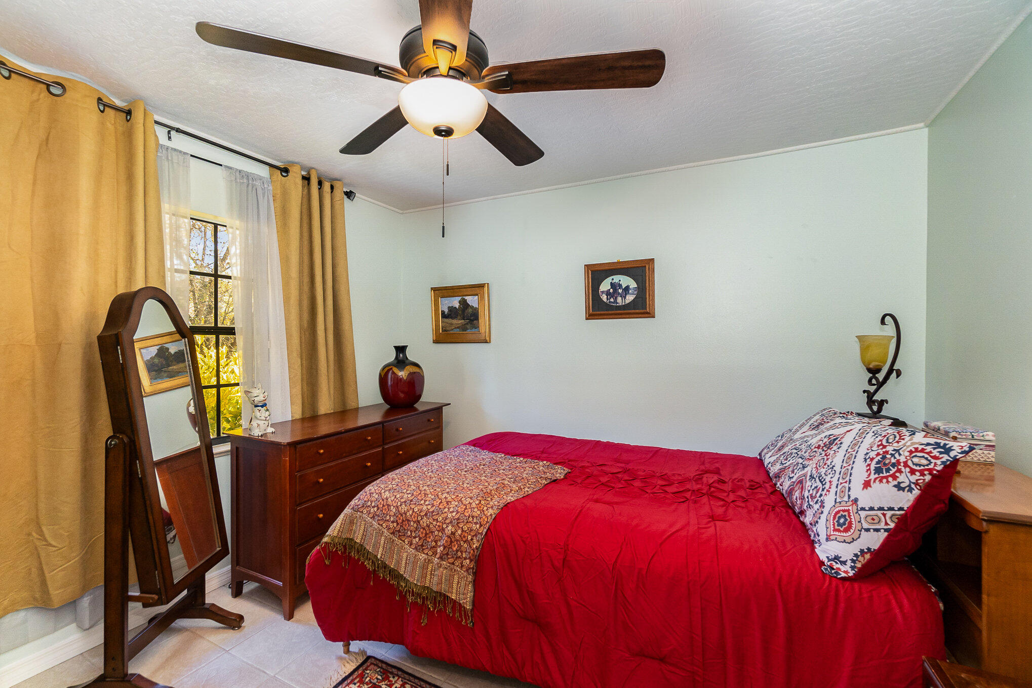 234 Deer Run Road Palm Bay, FL 32909 - Photo 24 of 50 a bedroom with a bed a window and chair
