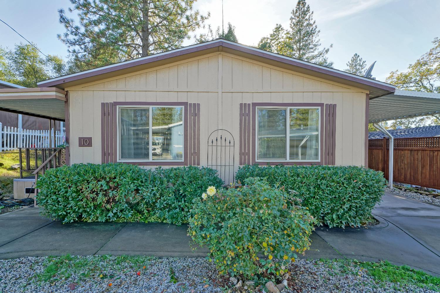 a view of a house with brick walls and flower plants
