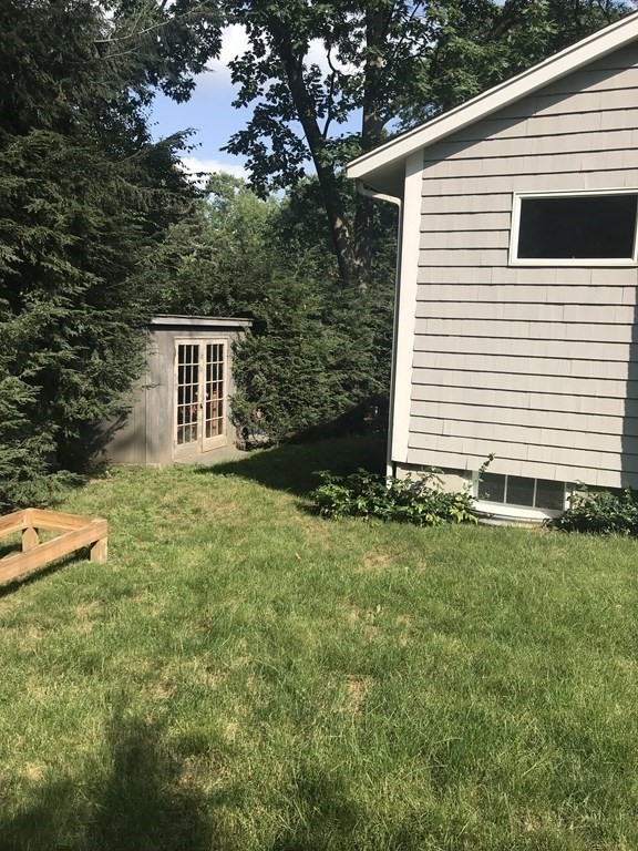 35 Sycamore Road Wayland, MA 01778 - Photo 36 of 42 a backyard of a house with lots of green space