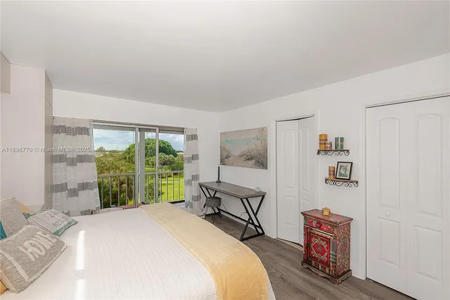 a bed room with a bed and a large window