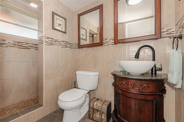 a bathroom with a toilet a sink and a shower