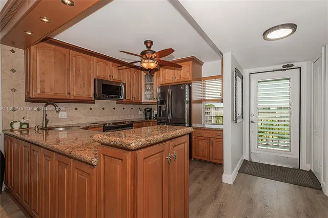 a kitchen with a stove a sink and a microwave