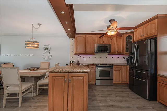 a kitchen with a sink appliances and cabinets