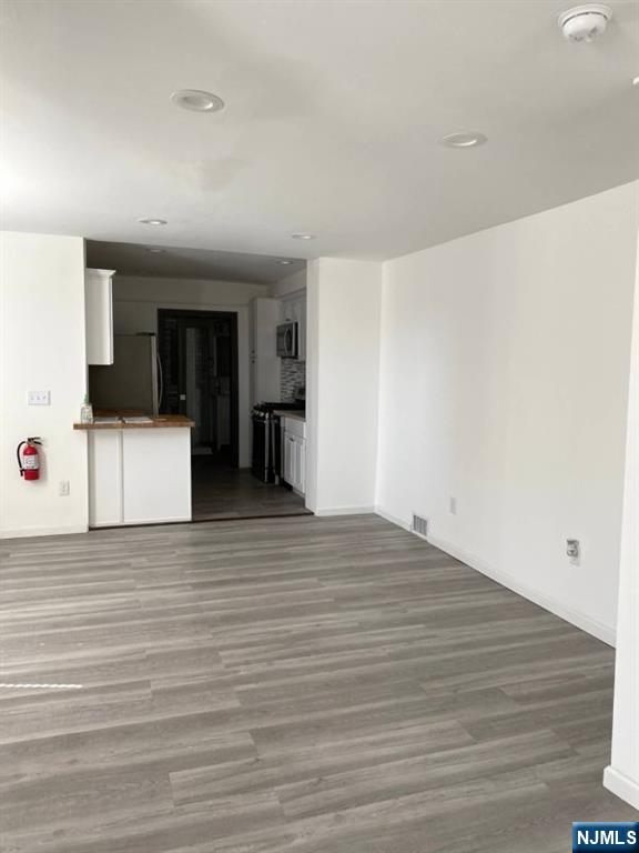454 Undercliff Avenue Edgewater, NJ 07020 - Photo 6 of 18 a view of empty room with wooden floor