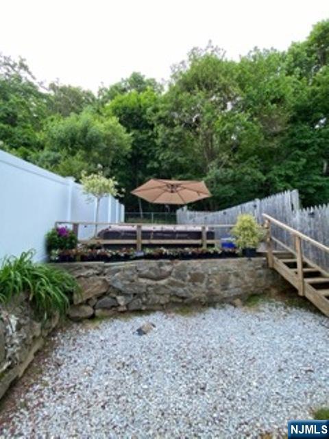 454 Undercliff Avenue Edgewater, NJ 07020 - Photo 9 of 18 a view of a yard with wooden fence