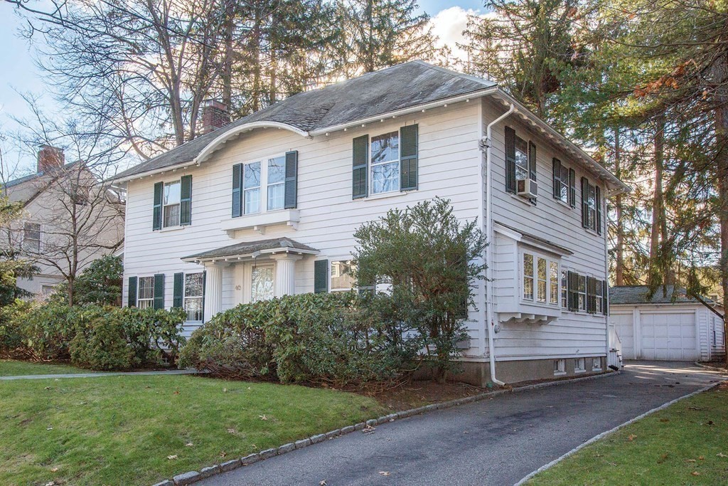 46 Pine Ridge Road Newton, MA 02468 - Photo 17 of 18 a front view of a house with a garden and trees