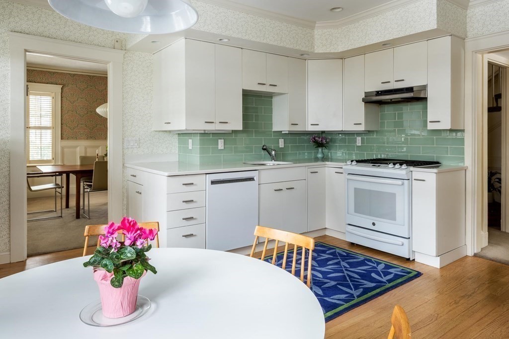 46 Pine Ridge Road Newton, MA 02468 - Photo 5 of 18 a kitchen with stainless steel appliances kitchen island granite countertop a stove a sink dishwasher and a refrigerator with wooden floor