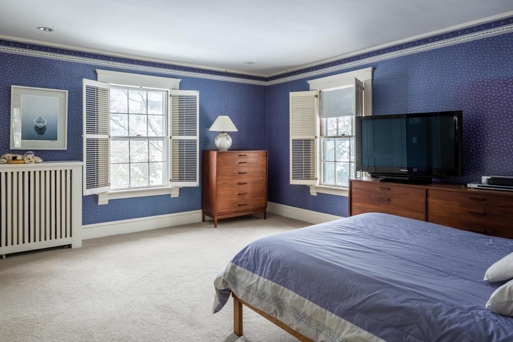 46 Pine Ridge Road Newton, MA 02468 - Photo 9 of 18 a bedroom with a bed and a flat screen tv