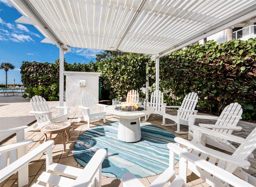 1050 Longboat Club Road, Unit 903 Longboat Key, FL 34228 - Photo 31 of 59 a view of a patio with table and chairs and potted plants