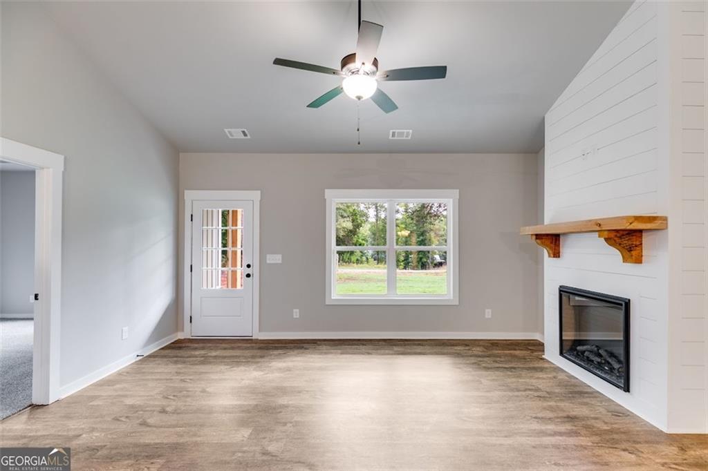 525 Grogan Road Buchanan, GA 30113 - Photo 16 of 40 an empty room with windows and fireplace