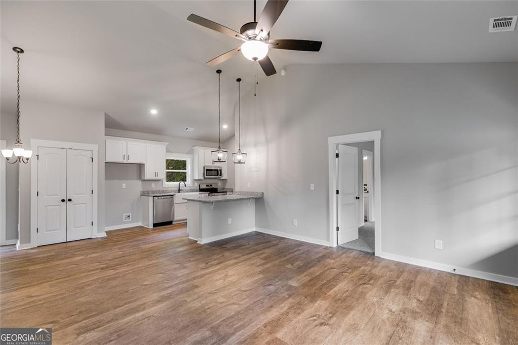 525 Grogan Road Buchanan, GA 30113 - Photo 18 of 40 a view of kitchen with wooden floor and window