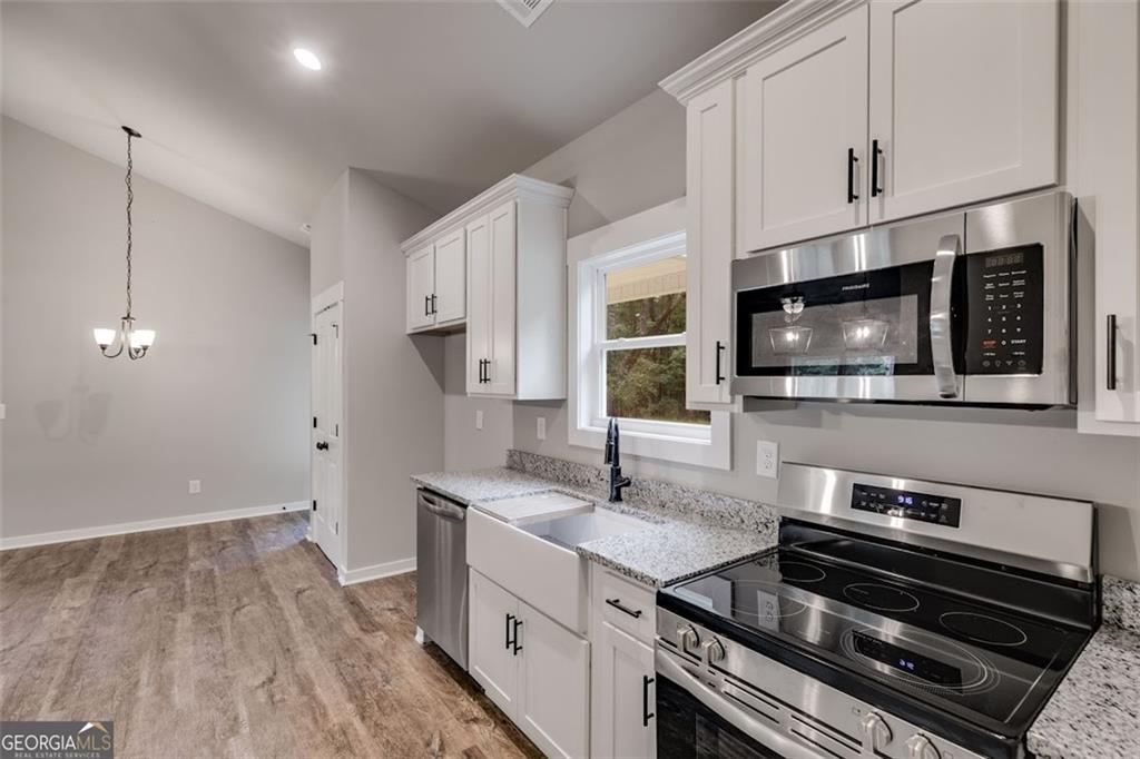 525 Grogan Road Buchanan, GA 30113 - Photo 23 of 40 a kitchen with a stove and a microwave