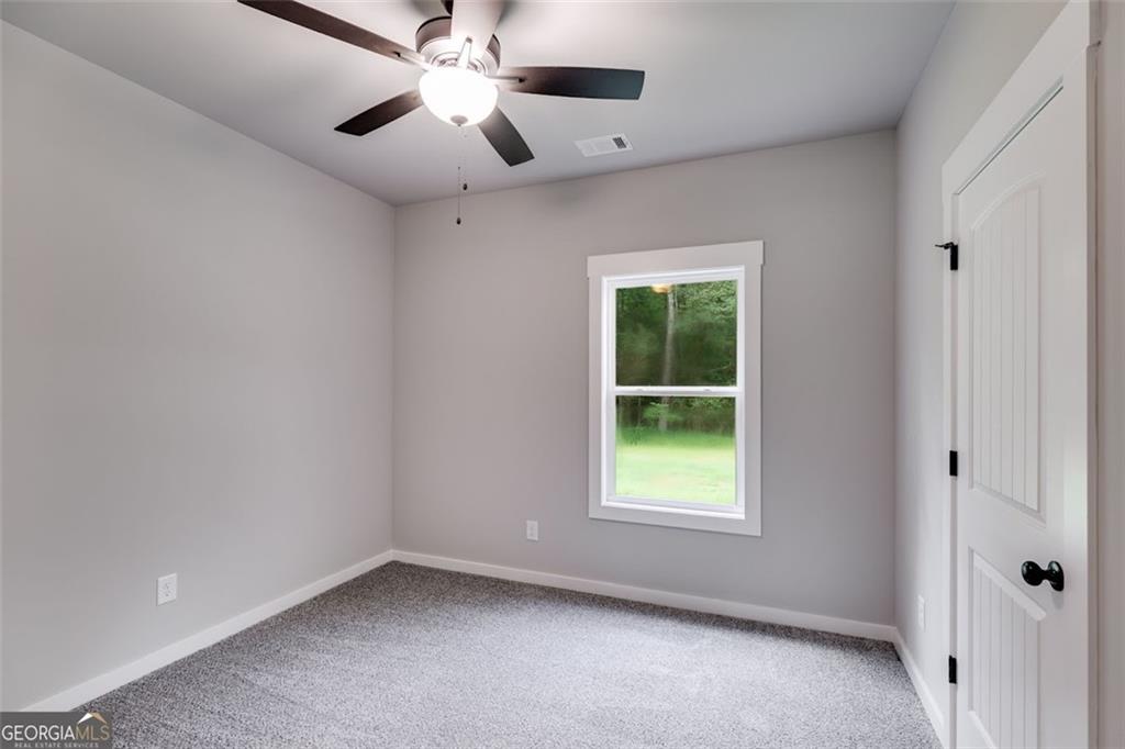 525 Grogan Road Buchanan, GA 30113 - Photo 36 of 40 an empty room with a window and a fan
