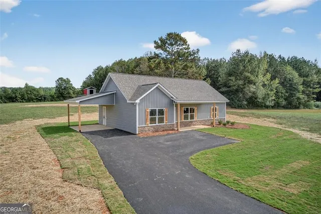 a view of house with outdoor space and sitting area