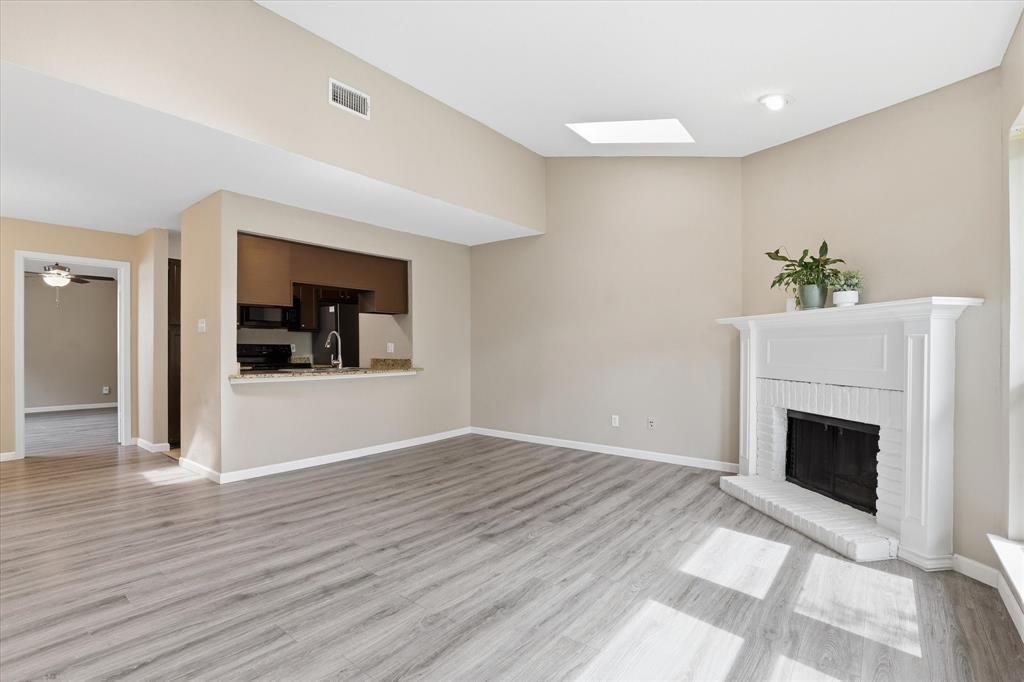 5616 Preston Oaks Road, Unit 404 Dallas, TX 75254 - Photo 11 of 34 Wood burning fireplace in the living room.