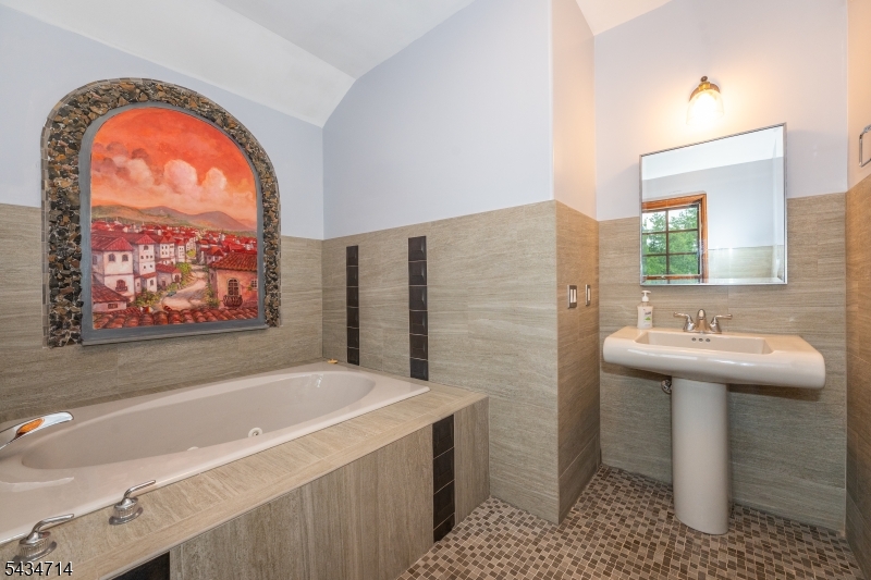50 Rock Spring Road West Orange, NJ 07052 - Photo 26 of 50 a bathroom with a sink a mirror and a bathtub