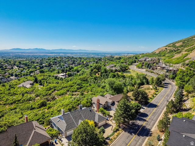 5057 South Ridgedale Drive Ogden, UT 84403 - Photo 63 of 69 Expansive residential area with a winding road among mature trees and lush green hillsides