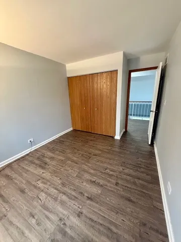 a view of hallway with wooden floor