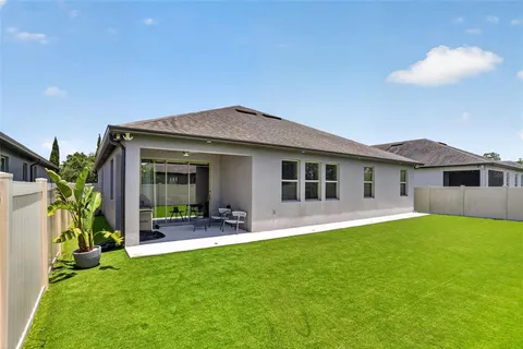 an aerial view of a house with a garden and swimming pool