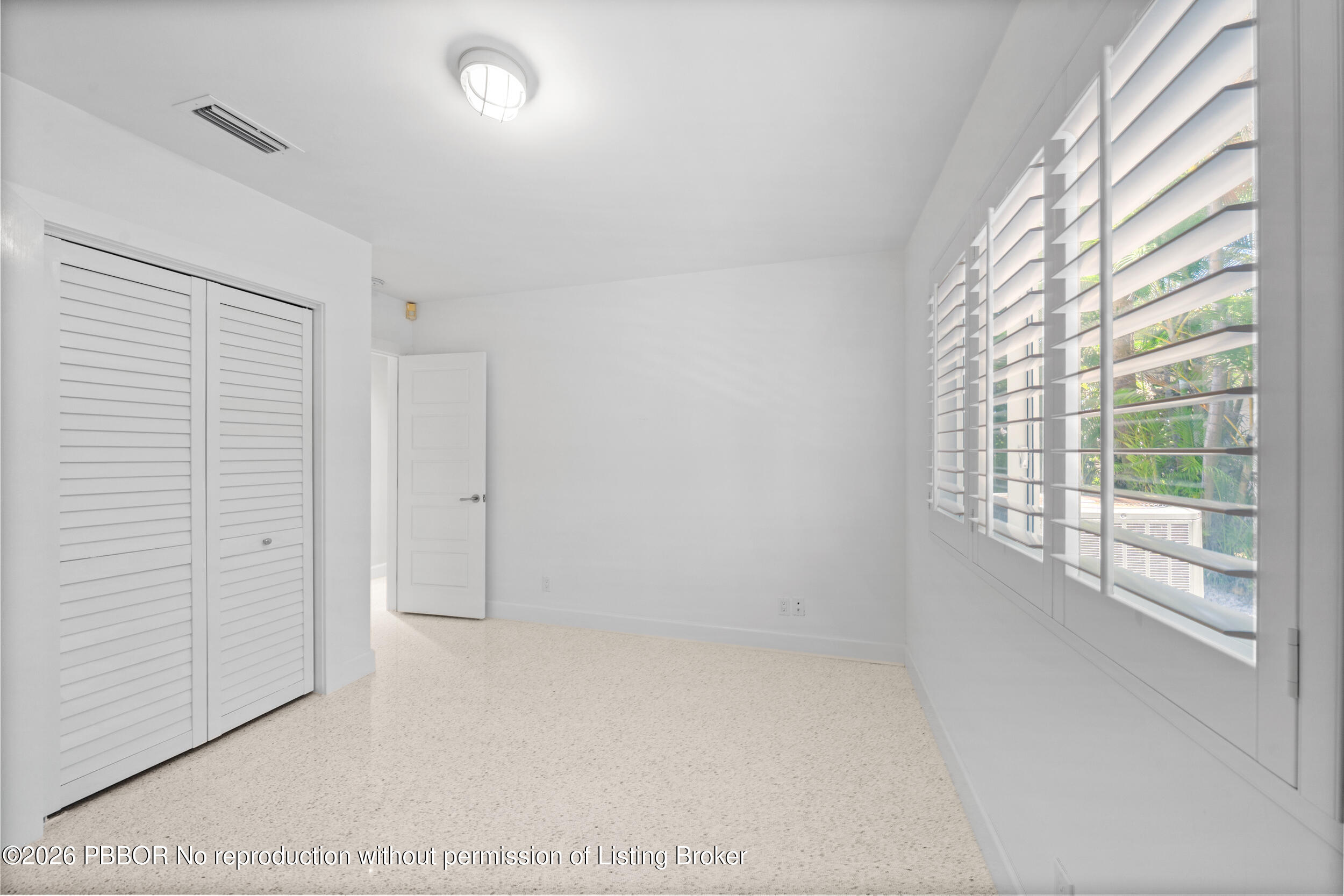 2259 Ibis Isle Road East, Unit E Palm Beach, FL 33480 - Photo 16 of 28 an empty room with windows