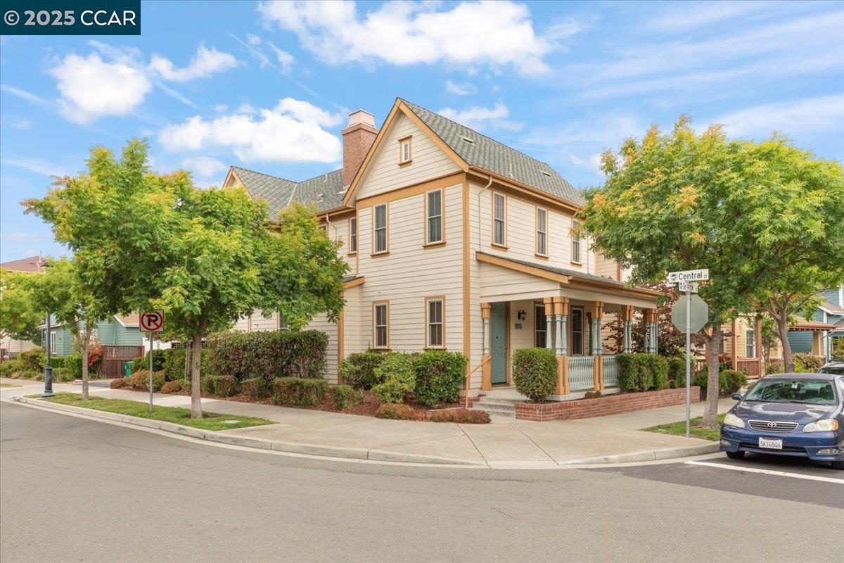 a view of a white house with a street